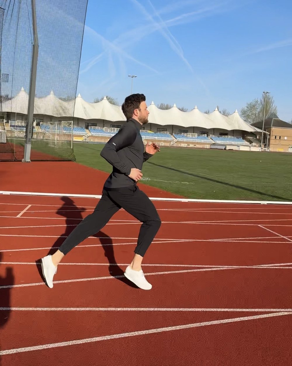 Chris running on an athletics track